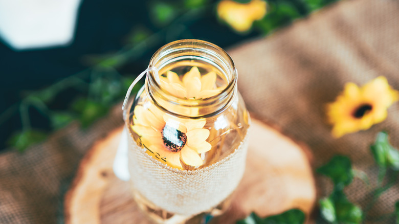 A glass container wrapped in burlap.