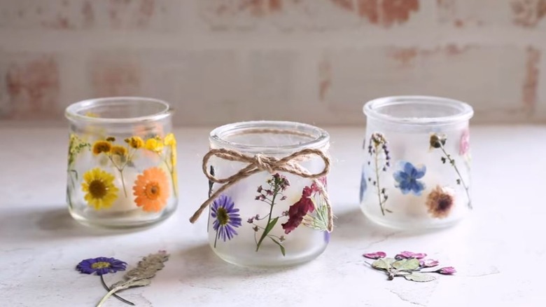 Glass jars covered in pressed flowers.
