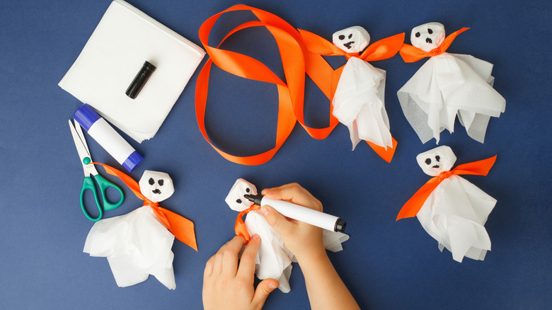 someone crafting napkin ghosts