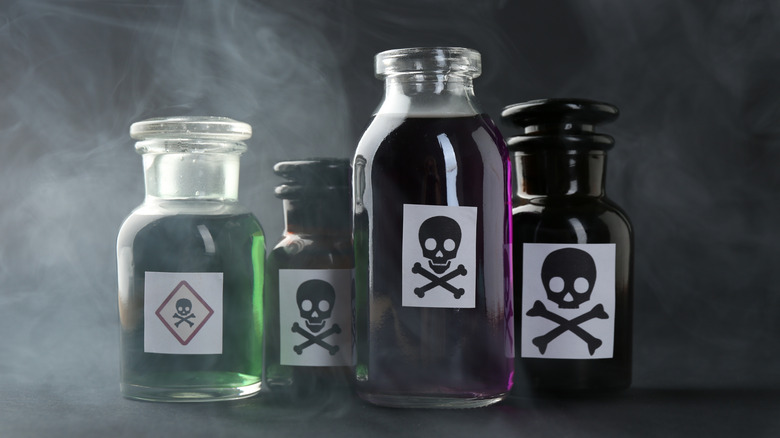four poison bottles with skull and crossbones sign on them