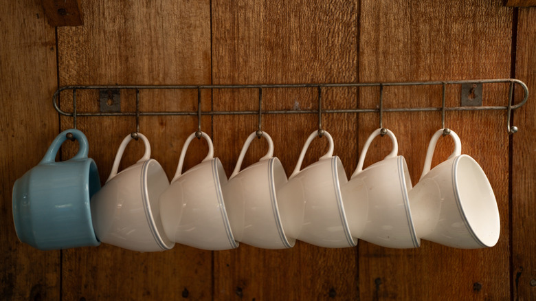 Teacups on wall hooks