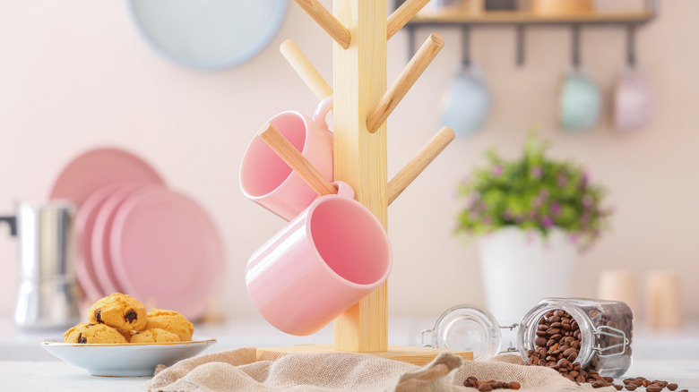 Pink mugs hanging off mug tree