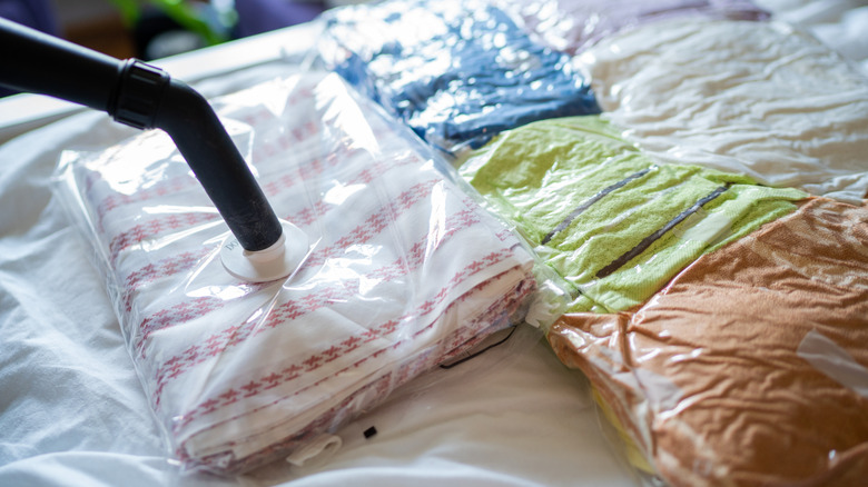 Person packing towels in vacuum bags