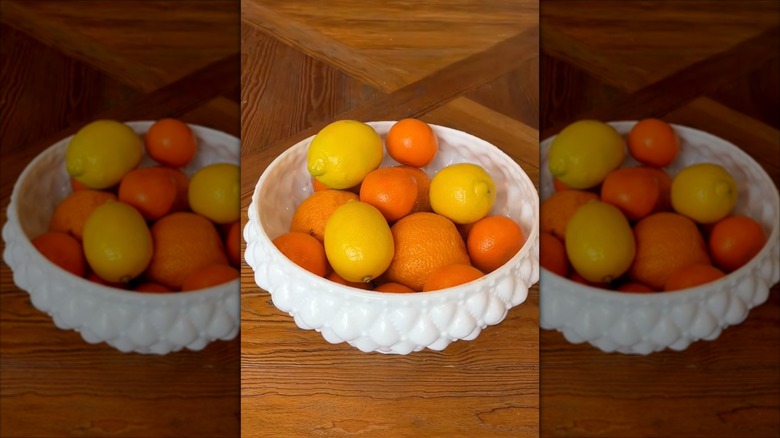 Thrifted glass lampshade turned upside down and used as a fruit bowl.