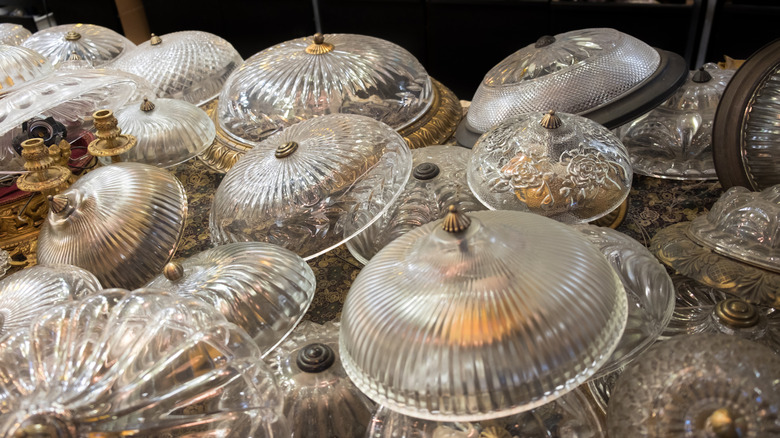 Glass lampshades for sale at thrift store.