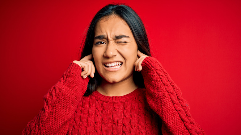 Woman reacting to loud noise