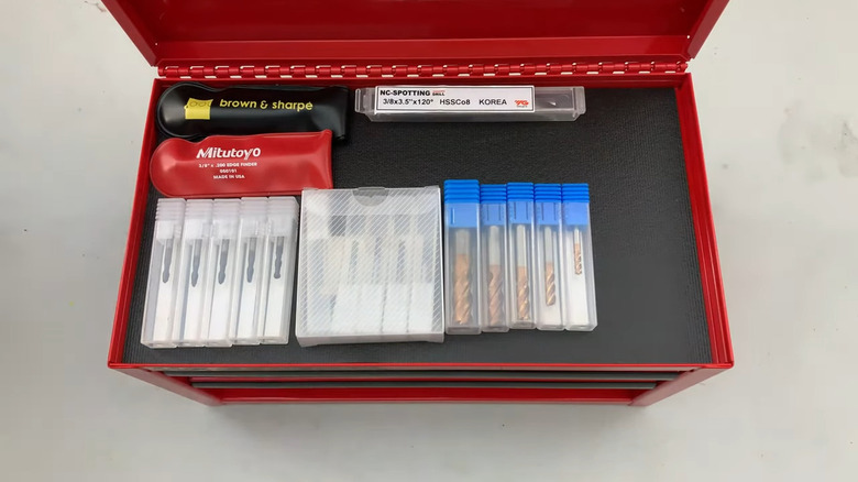Drill bits and similar items inside red mini toolbox