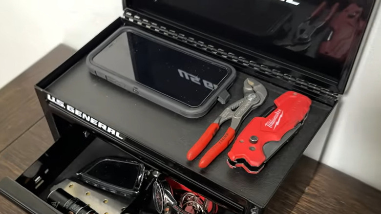 a phone and some tools in a U.S. General mini toolbox