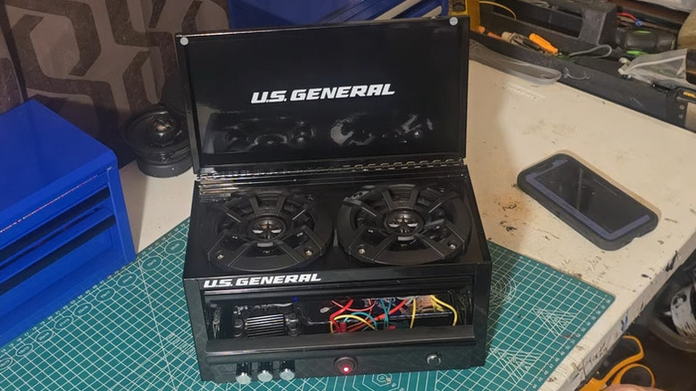 Mini toolbox with wires and speakers installed to make a mini boombox
