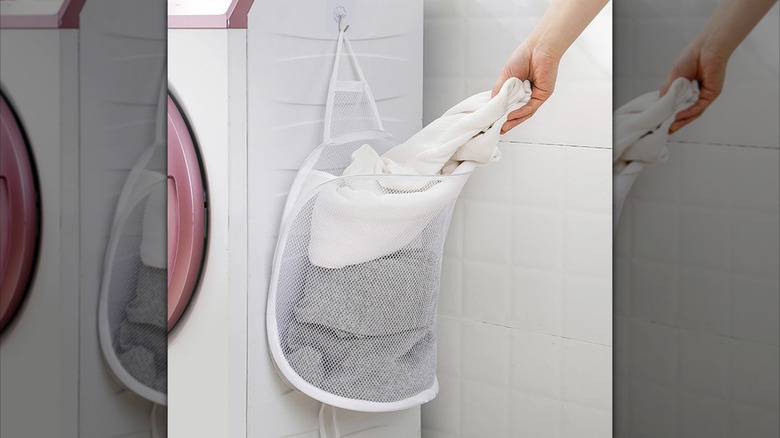 a mesh laundry basket similar to those used for hanging filled with clothes