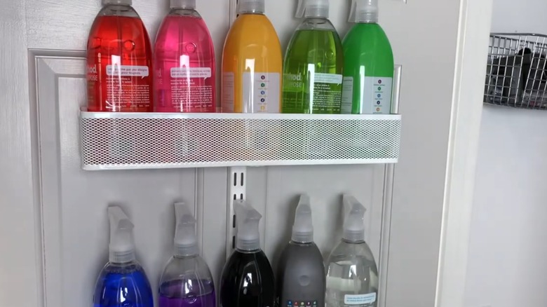 cleaning supplies organized on door using wire baskets
