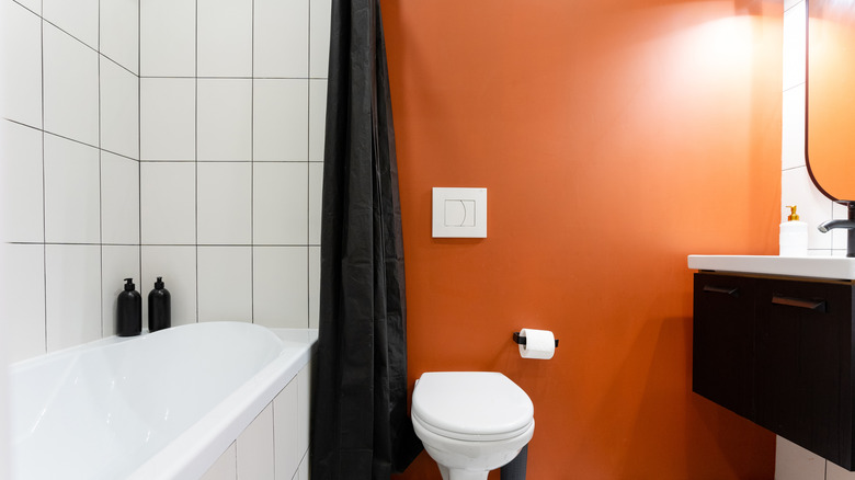 bathroom with bright orange wall