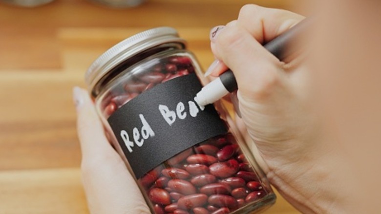 Person writing on chalk label