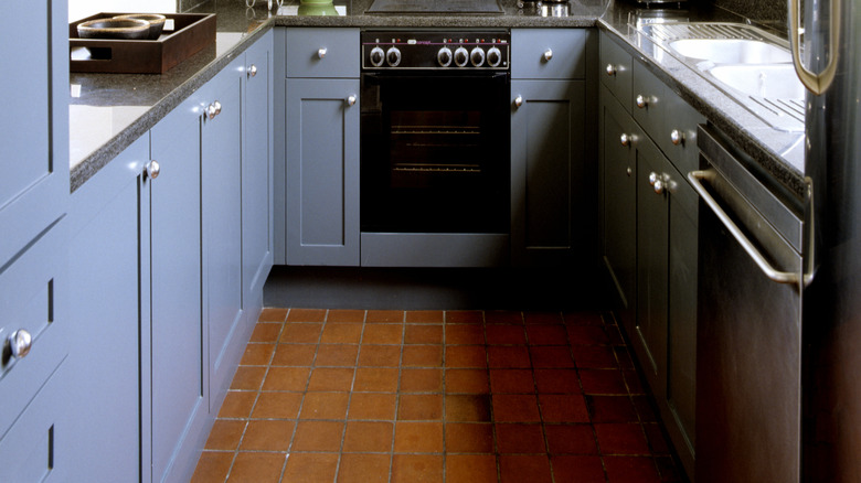 brick floor in blue kitchen