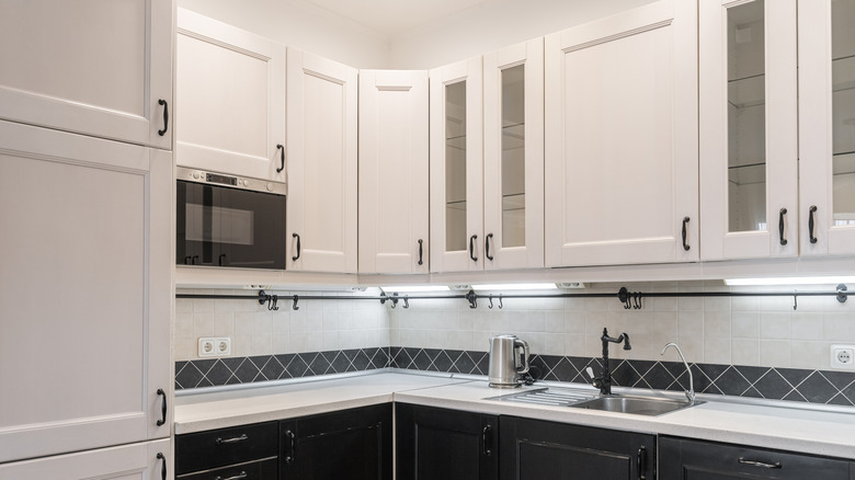 White and black kitchen with built-in appliances