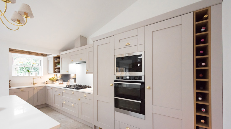 Cream kitchen with built-in appliances and gold hardware