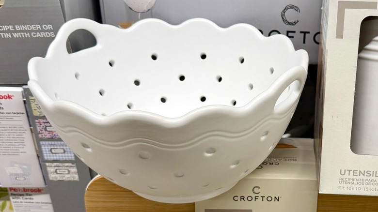 a white scalloped ceramic colander