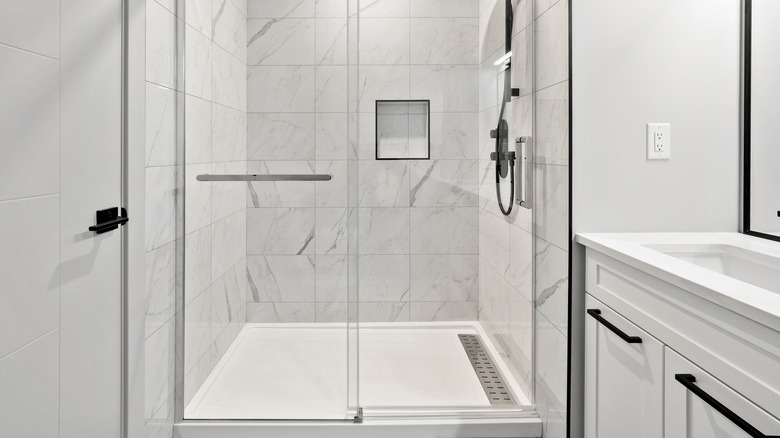 white tiled shower with tray