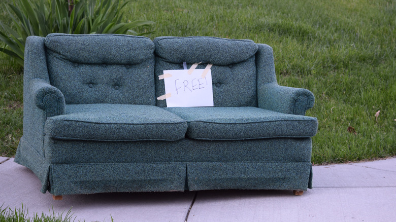 Blue couch with a sign that says FREE on it