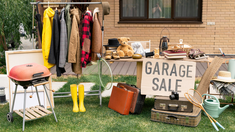 Various clothing and home goods on display at garage sale
