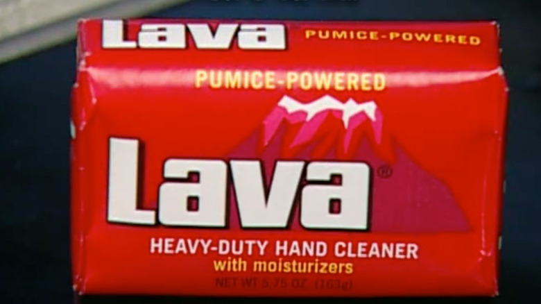 A vintage bar of Lava soap on a black tabletop.