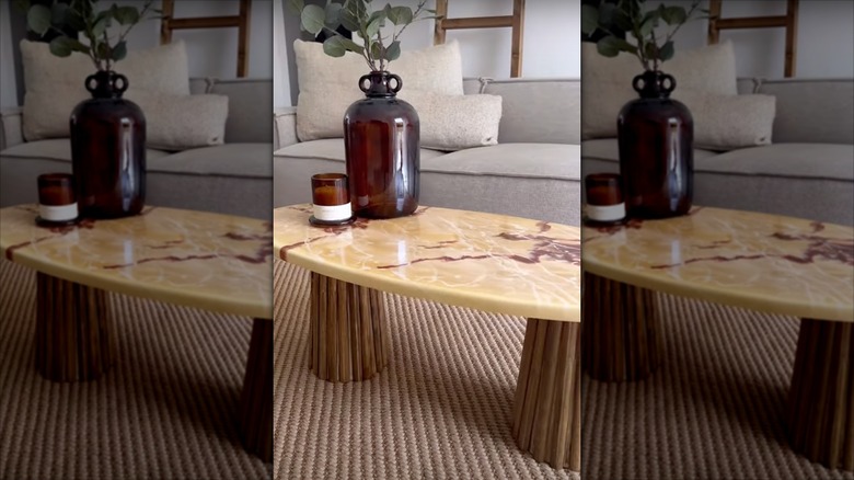 A stone coffee table with plant stands used as legs