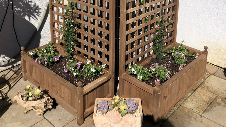 Two trellis planter boxes used to hide unsightly outdoor unit on porch