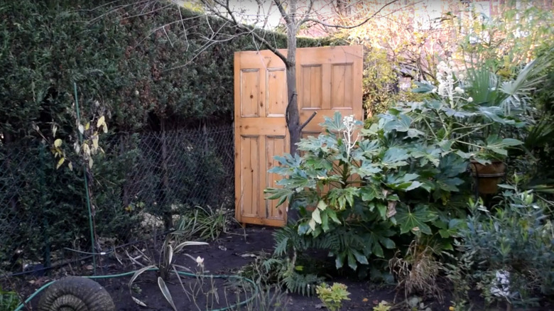 Upcycled wood doors blocking yard outside