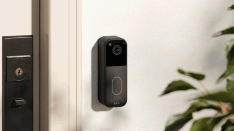 video doorbell on wall next to door