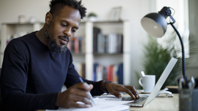 man working at organized desk