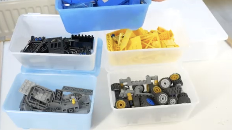 A set of IKEA GLIS boxes holding assorted LEGO bricks and components.