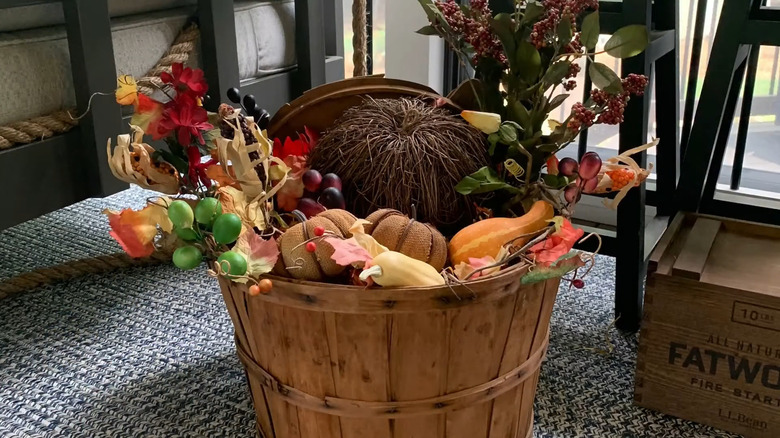 A person assembling a harvest basket