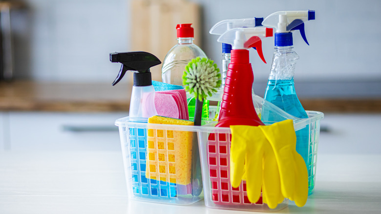 Cleaning supplies in a plastic basket.