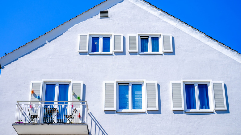 white shutters against white home