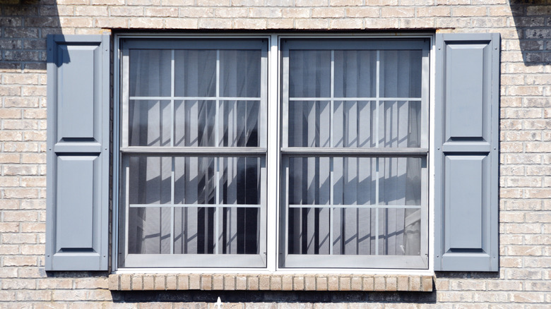 steel gray shutters on brick home