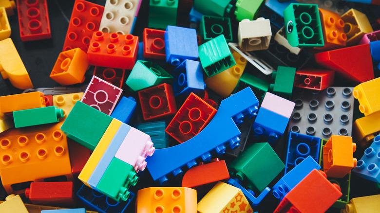 Collection of LEGO building toys of various colors