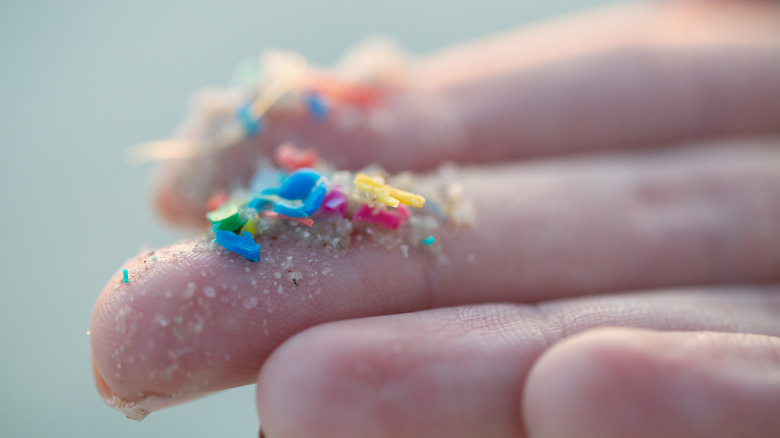 Sand, confetti, and glitter on a person's fingerprints