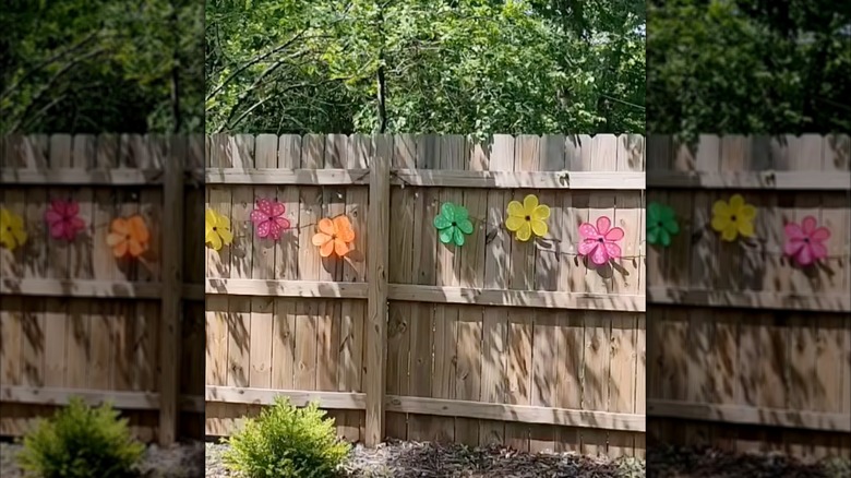 A fence with colorful pinwheels