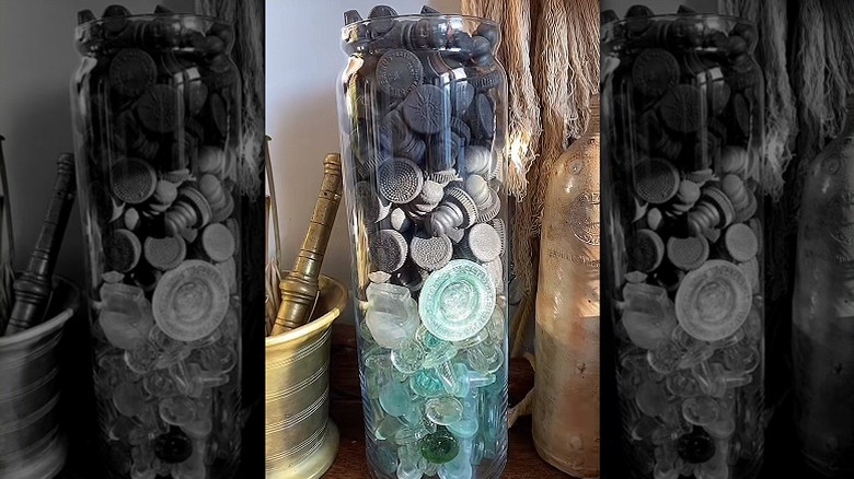 Various glass bottle stoppers in vase