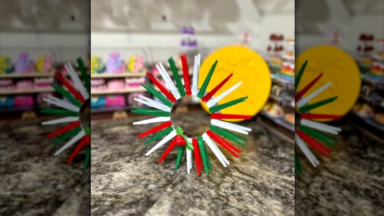 tabletop Christmas ornament made of red, white, and green mini tongs
