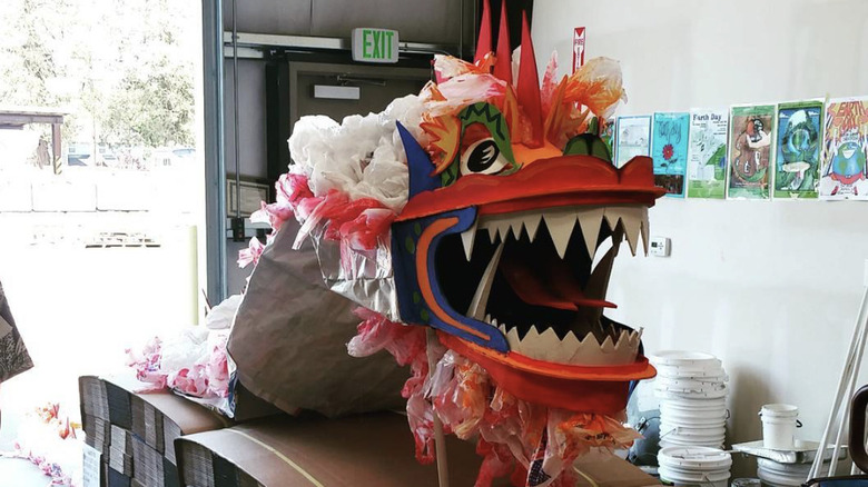 A vibrant dragon made with sleeping bags and cardboard