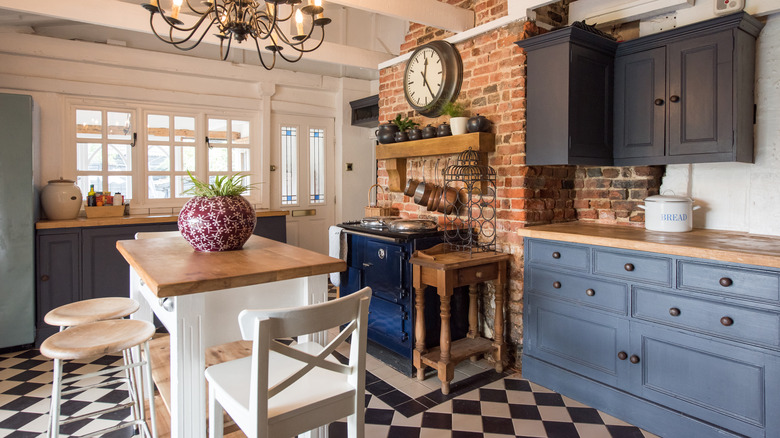 A country style kitchen with a tiled floor.