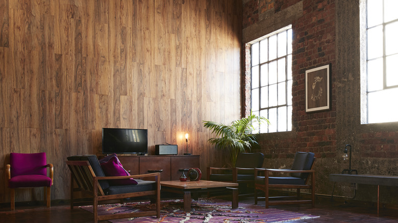 A modern loft with a wood panel wall.