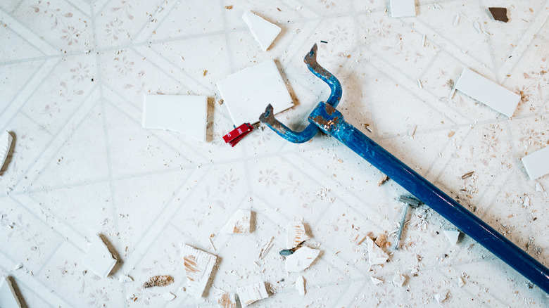 Removing and destroying white vintage tiles.