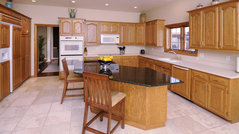 A dated kitchen with all wood cabinetry.
