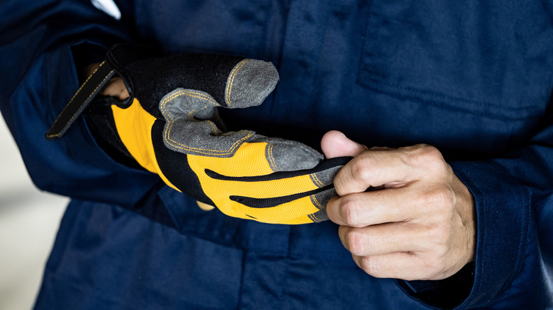 A man wearing a pair of DeWalt branded gloves.