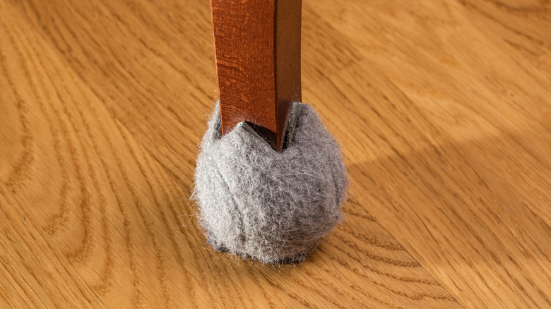 old tennis ball on chair leg