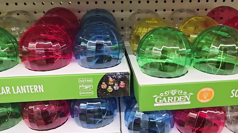 A closeup photo shows colorful solar lanterns on shelves at a Dollar Tree