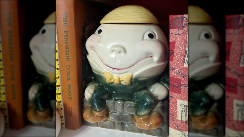 Humpty Dumpty cookie jar on bookshelf