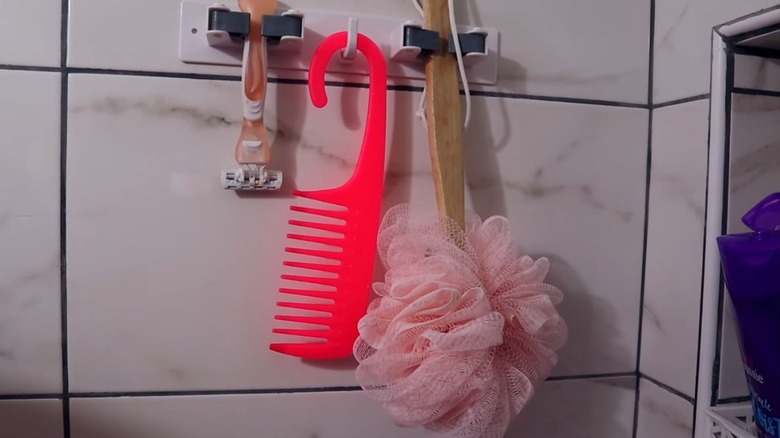 A Dollar Tree broom holder holds shower essentials.
